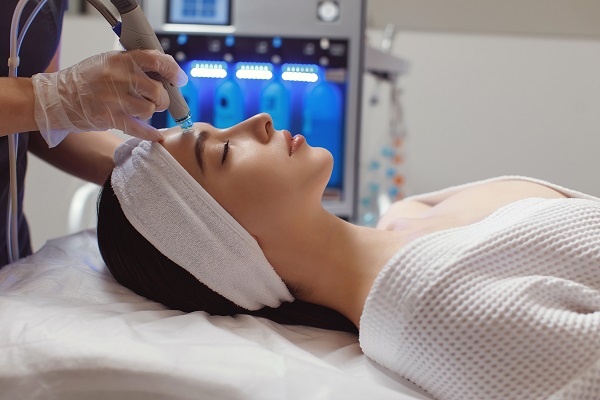 Side,View,Of,Woman,Receiving,Microdermabrasion,Therapy,On,Forehead,At