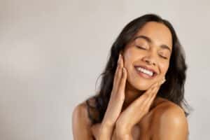 Woman smiling with glowing skin from laser skin resurfacing in East Greenwich, RI