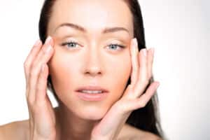 Woman lifting the eye area wanting eyelid surgery in Greenwich, RI